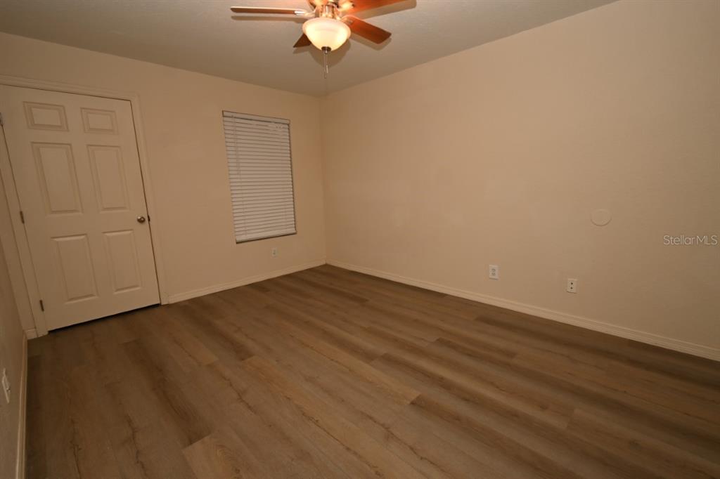 36047 Deer Creek Drive, Unit 102 Zephyrhills, FL 33541 - Photo 12 of 37 wooden floor in an empty room