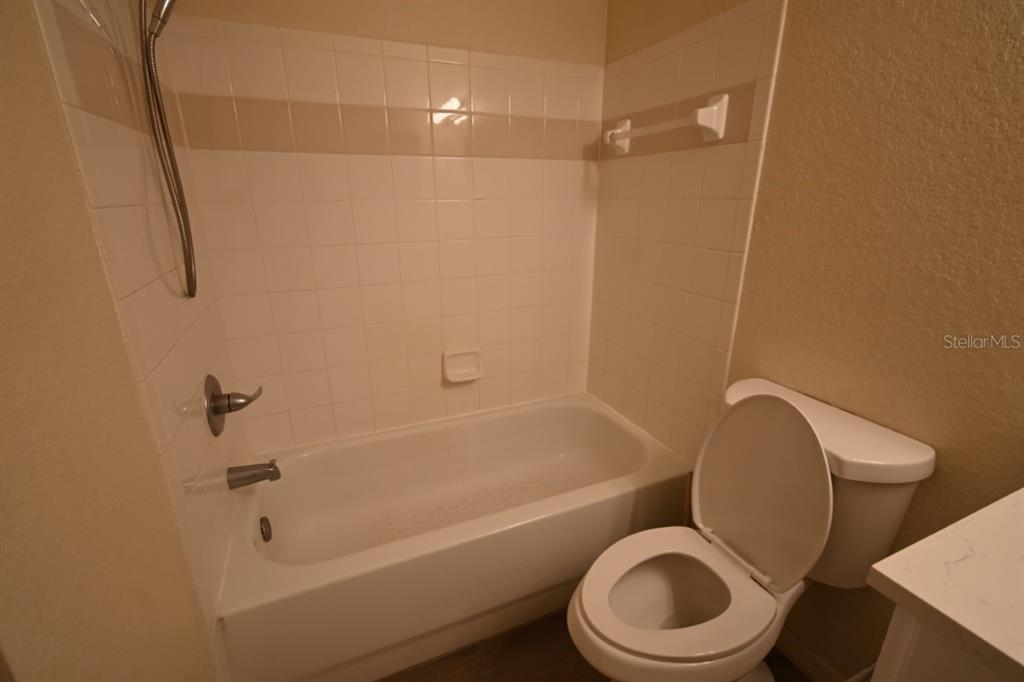 36047 Deer Creek Drive, Unit 102 Zephyrhills, FL 33541 - Photo 14 of 37 a bathroom with a toilet and a bath tub