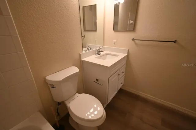 a white toilet sitting next to a bathroom sink