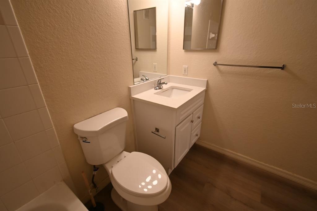 36047 Deer Creek Drive, Unit 102 Zephyrhills, FL 33541 - Photo 15 of 37 a white toilet sitting next to a bathroom sink