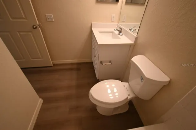 a bathroom with a toilet and a mirror