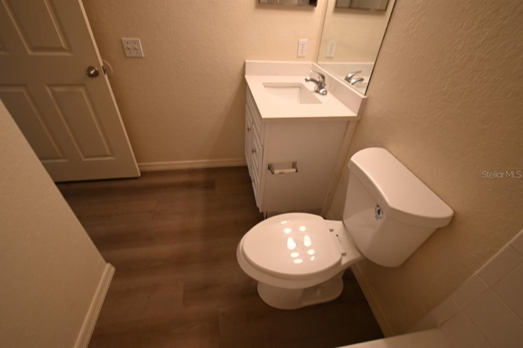 36047 Deer Creek Drive, Unit 102 Zephyrhills, FL 33541 - Photo 19 of 37 a bathroom with a toilet and a mirror