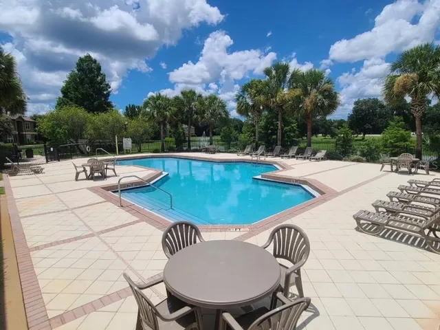 a view of a swimming pool with a yard