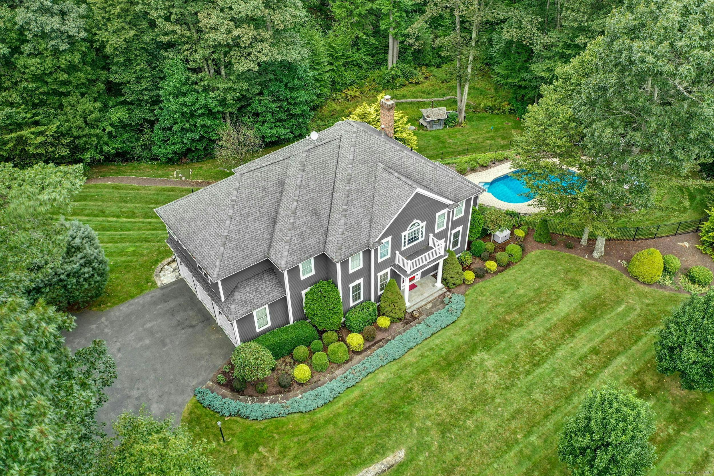 aerial view of a house with a yard and potted plants