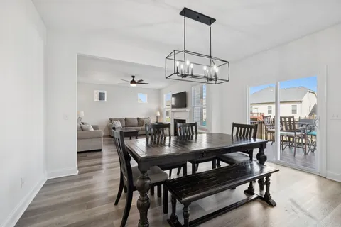 a view of a dining room with furniture wooden floor and chandelier