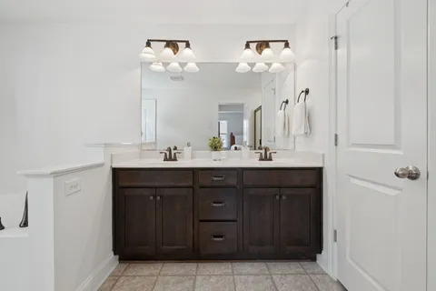 a bathroom with a vanity a sink a mirror and a vanity