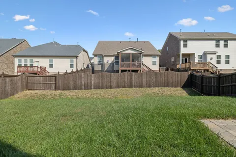 an aerial view of a house with swimming pool and a yard