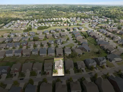 an aerial view of residential houses with outdoor space