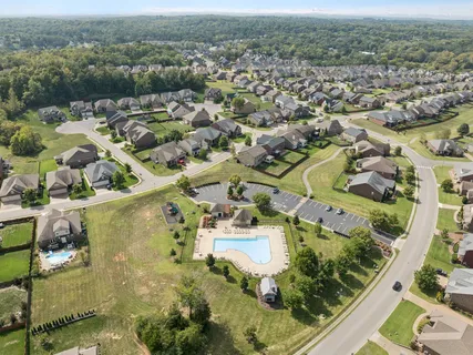 an aerial view of residential houses with outdoor space and street view