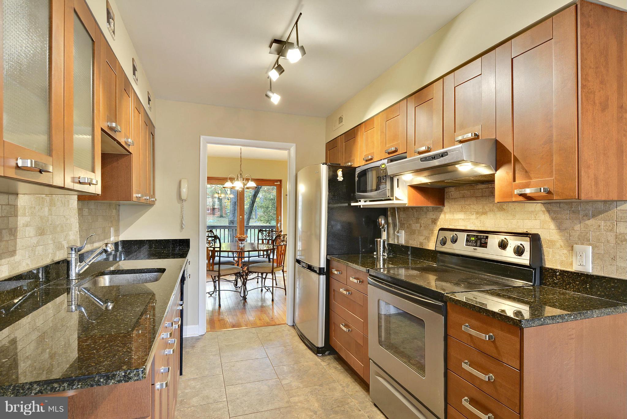 2024 Golf Course Drive Reston, VA 20191 - Photo 13 of 30 a kitchen with stainless steel appliances granite countertop a stove and a sink
