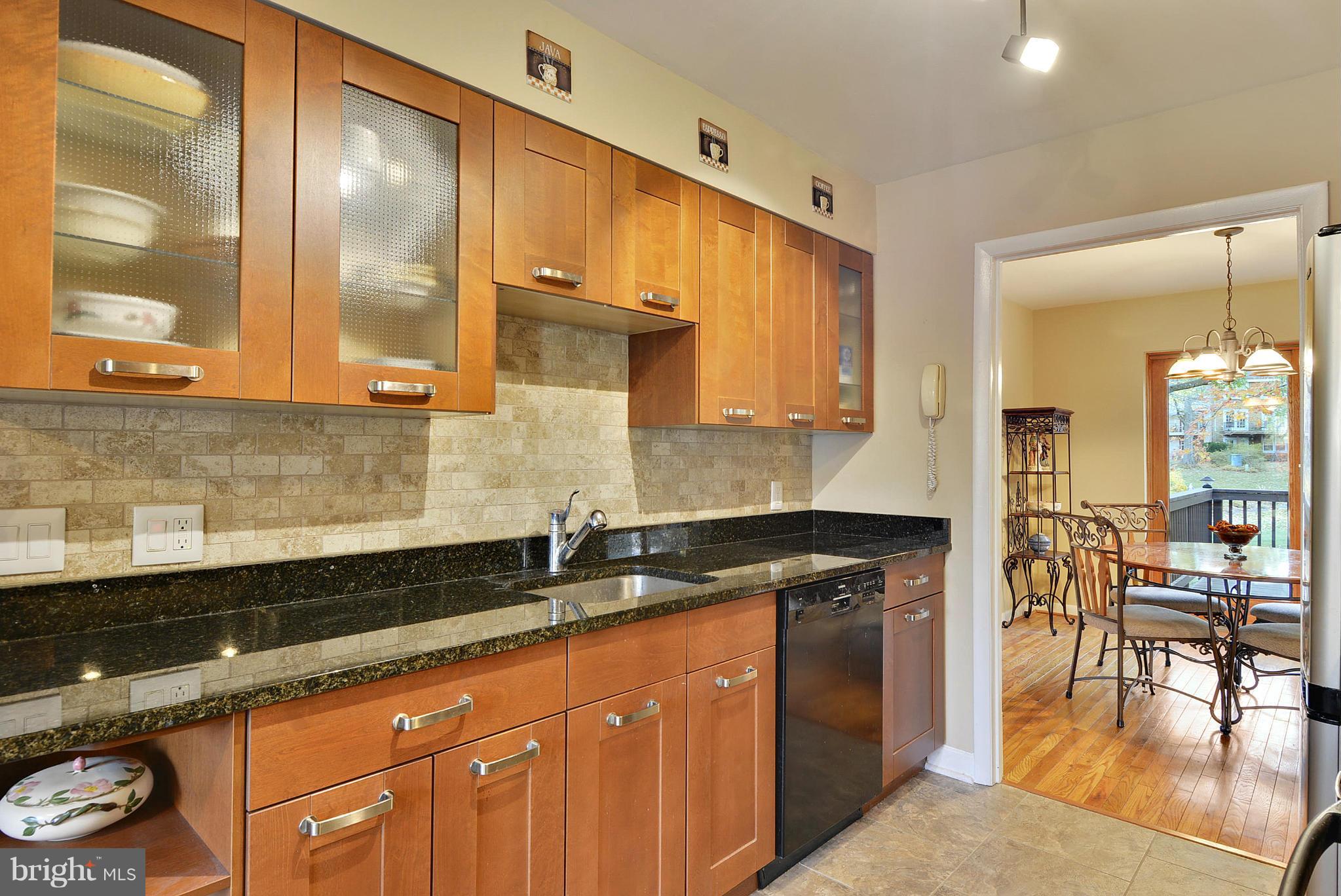 2024 Golf Course Drive Reston, VA 20191 - Photo 14 of 30 a kitchen with granite countertop a sink a stove and cabinets