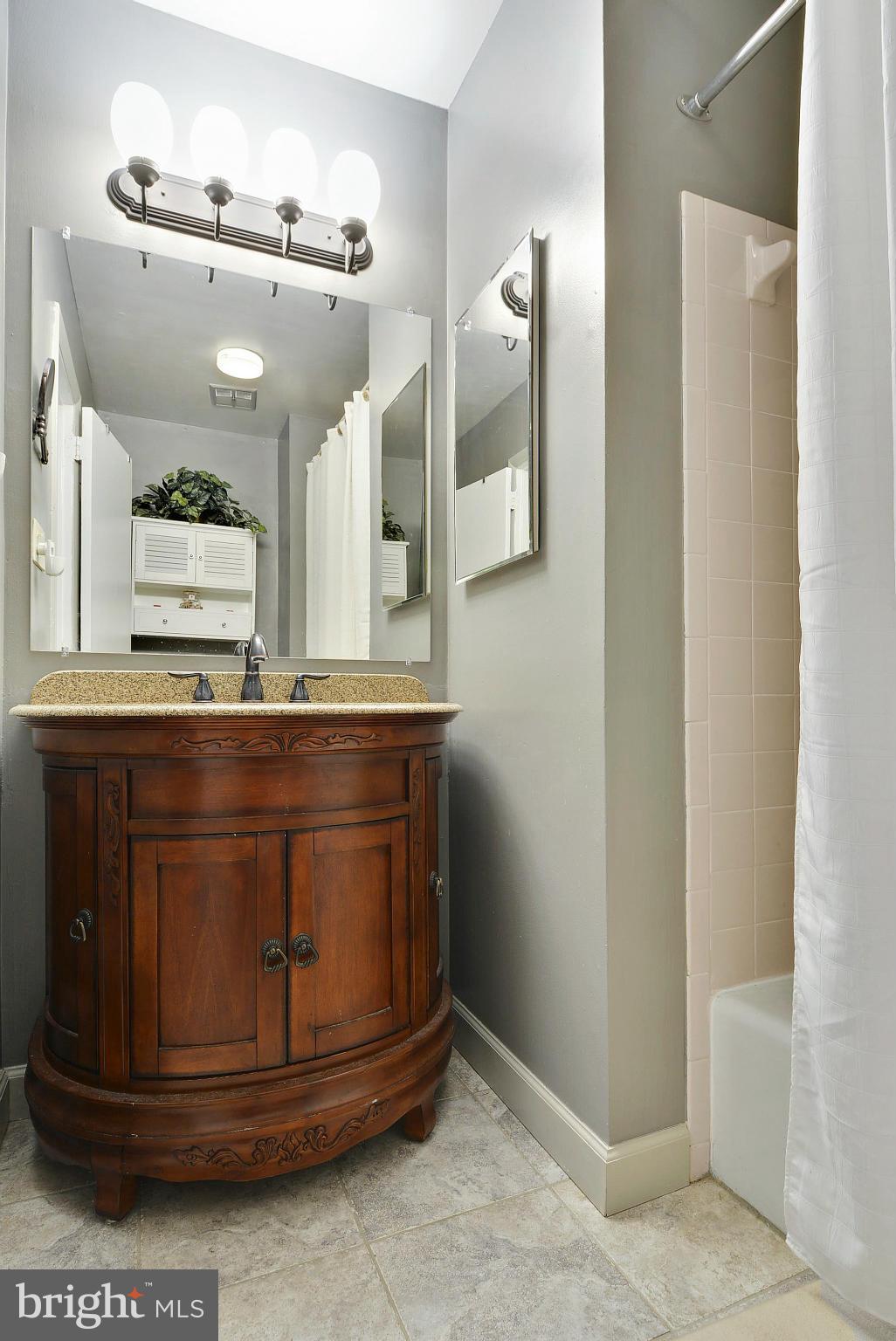 2024 Golf Course Drive Reston, VA 20191 - Photo 22 of 30 a bathroom with a granite countertop sink and a mirror