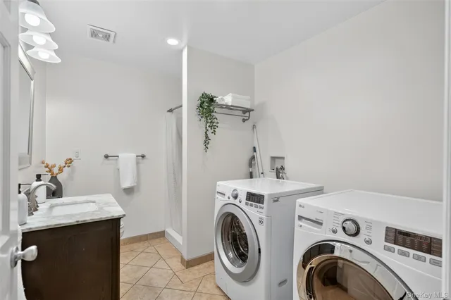 a view of a bathroom with sink washer and dryer