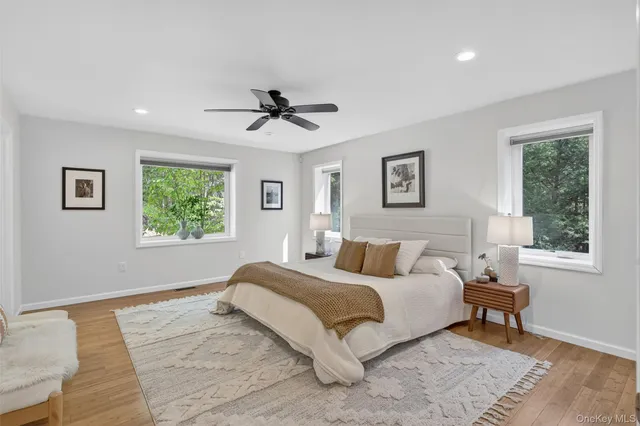 a spacious bedroom with a large bed and a window