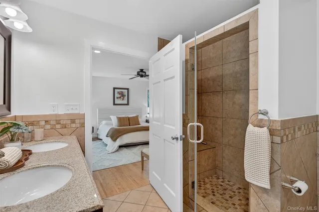 a bathroom with a tub sink and shower