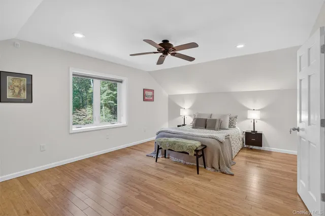 a bed room with a bed and a ceiling fan