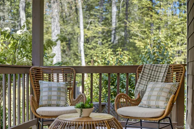 a view of a chair and table in the balcony