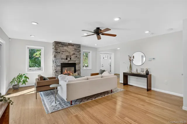 a living room with furniture a fireplace and a chandelier