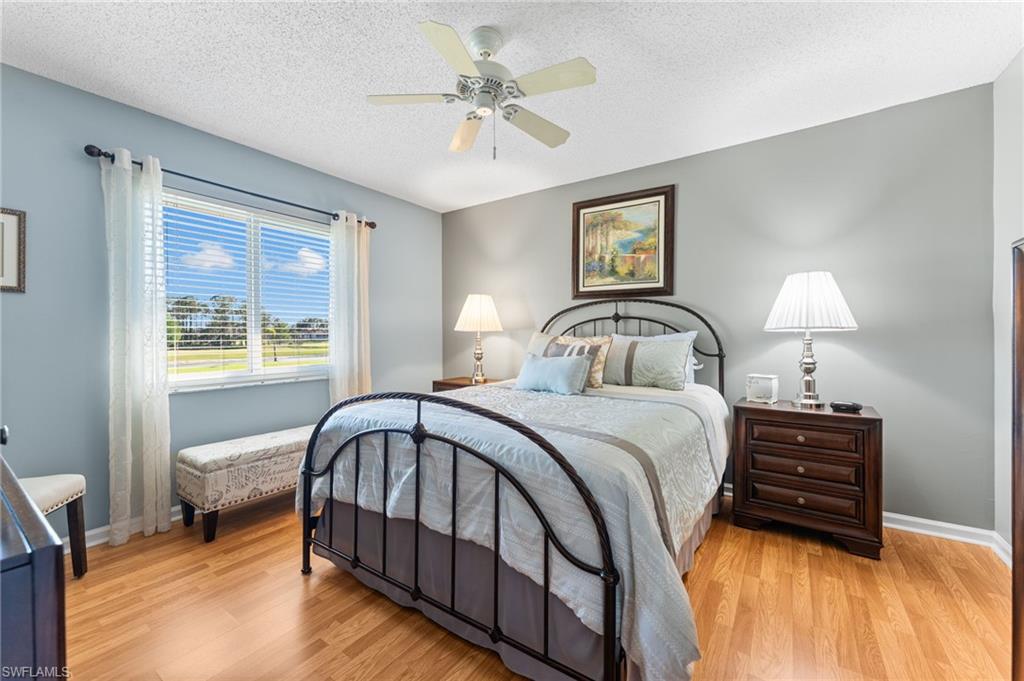 5928 Cranbrook Way, Unit D202 Naples, FL 34112 - Photo 8 of 23 Bedroom with ceiling fan, baseboards, and light wood-style floors