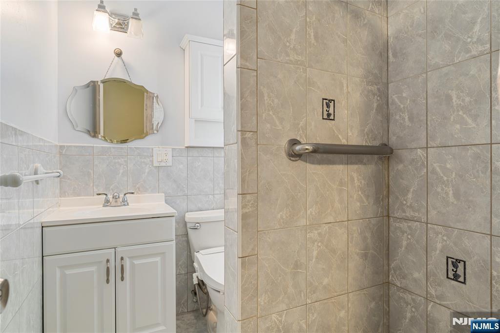 60 White Oak Road Parsippany, NJ 07054 - Photo 11 of 24 a bathroom with a sink vanity and mirror