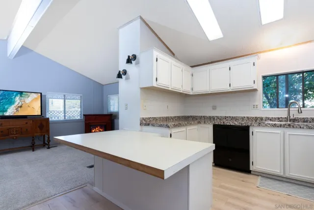 a kitchen with a refrigerator a stove a sink dishwasher and a refrigerator with wooden floor