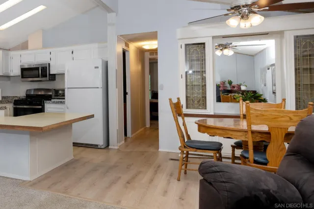 a view of a dining room with furniture and chandelier