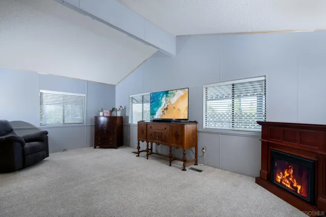 a large white kitchen with stainless steel appliances refrigerator stove microwave and cabinets