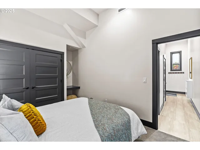 a bedroom with a bed and a painting on the wall