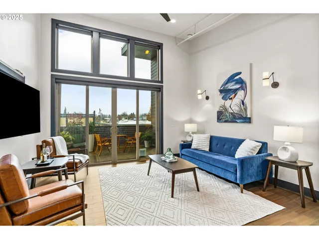 a view of a balcony with chairs and a potted plant