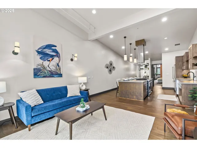 a living room with kitchen island granite countertop furniture and a potted plant