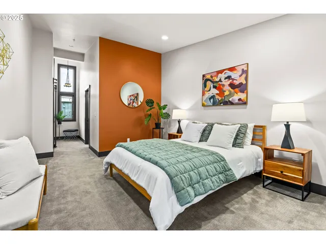 a bedroom with a bed and a painting on the wall