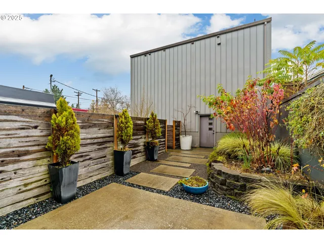 a view of a backyard with plants and a painting