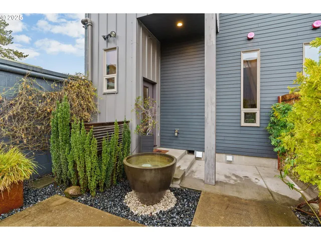 a view of a porch with plants and trees