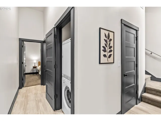 a bedroom with a bed and a painting on the wall