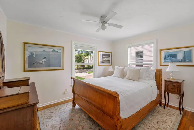 a bedroom with a bed and a lamp on dresser