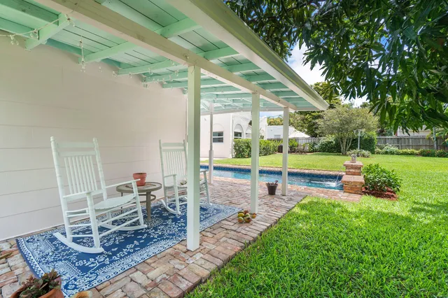 a view of a house with backyard sitting area and garden