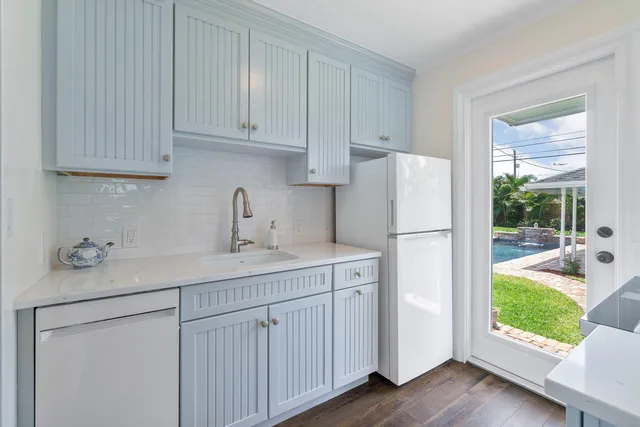 a kitchen with a sink appliances and cabinets