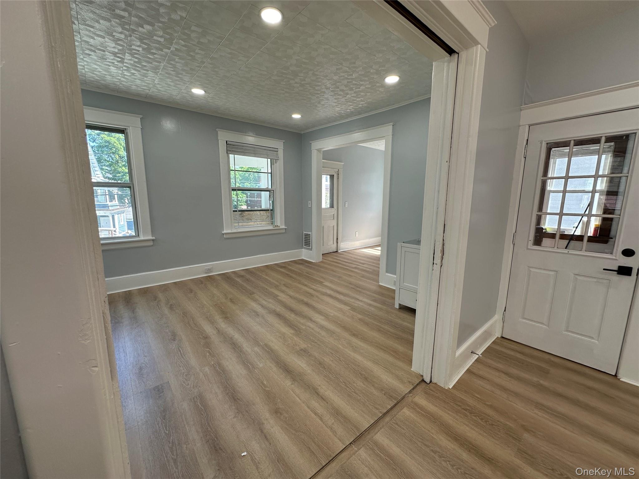 15 Forbus Street Poughkeepsie, NY 12601 - Photo 3 of 9 an empty room with wooden floor and windows