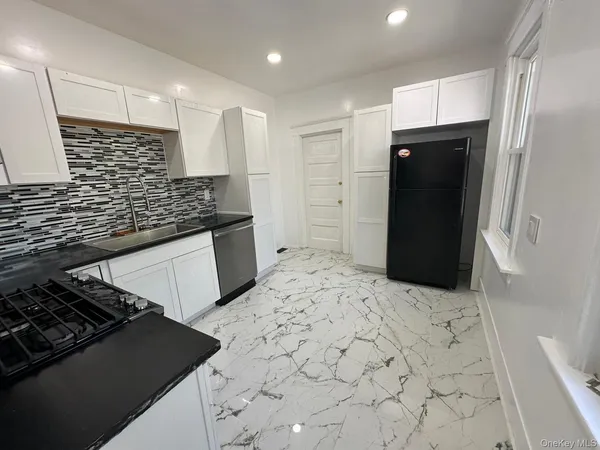 a kitchen with a stove and a refrigerator