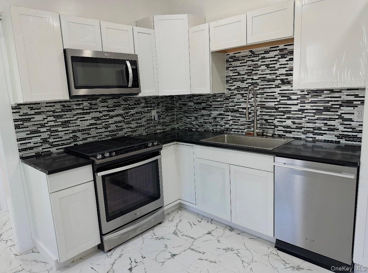 15 Forbus Street Poughkeepsie, NY 12601 - Photo 5 of 9 a kitchen with granite countertop white cabinets and stainless steel appliances