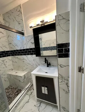 a bathroom with a sink toilet and mirror