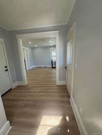 a view of a hallway with wooden floor