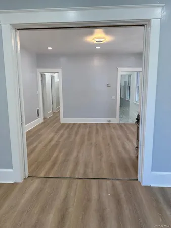 a view of a big room with wooden floor and cabinet
