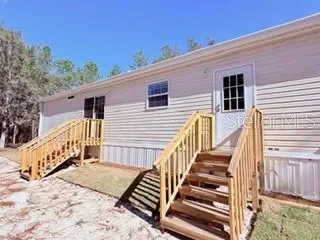 a view of a house with wooden fence