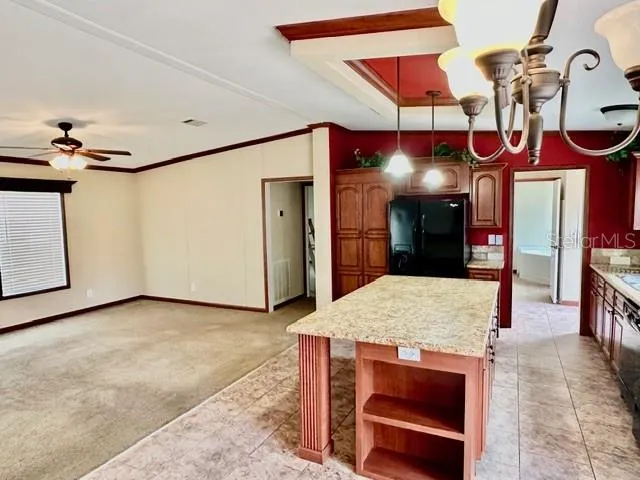 a kitchen area with granite countertop a sink and cabinets