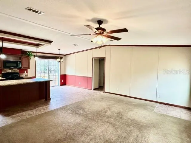 a view of a kitchen with furniture and a ceiling fan