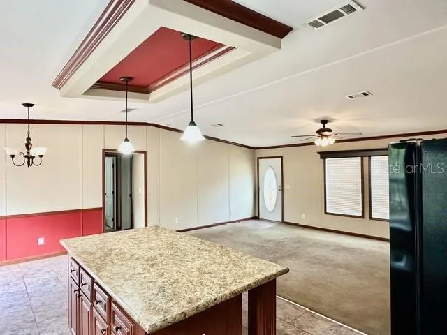 a view of a kitchen with a sink and a refrigerator