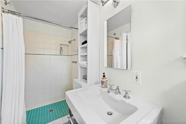 a bathroom with a sink a mirror and a shower