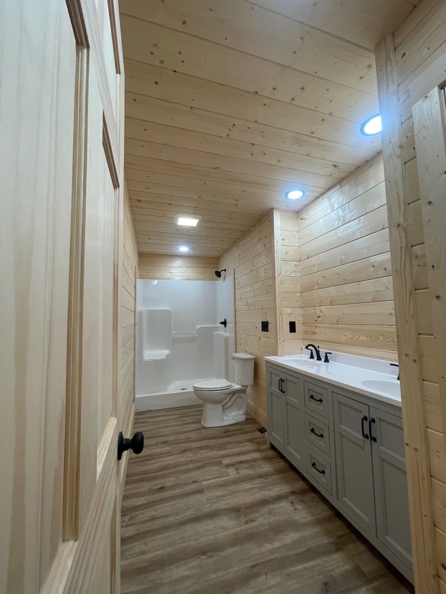 60 Trout Pass Mathias, WV 26812 - Photo 27 of 46 a bathroom with a double vanity sink and mirror with shower