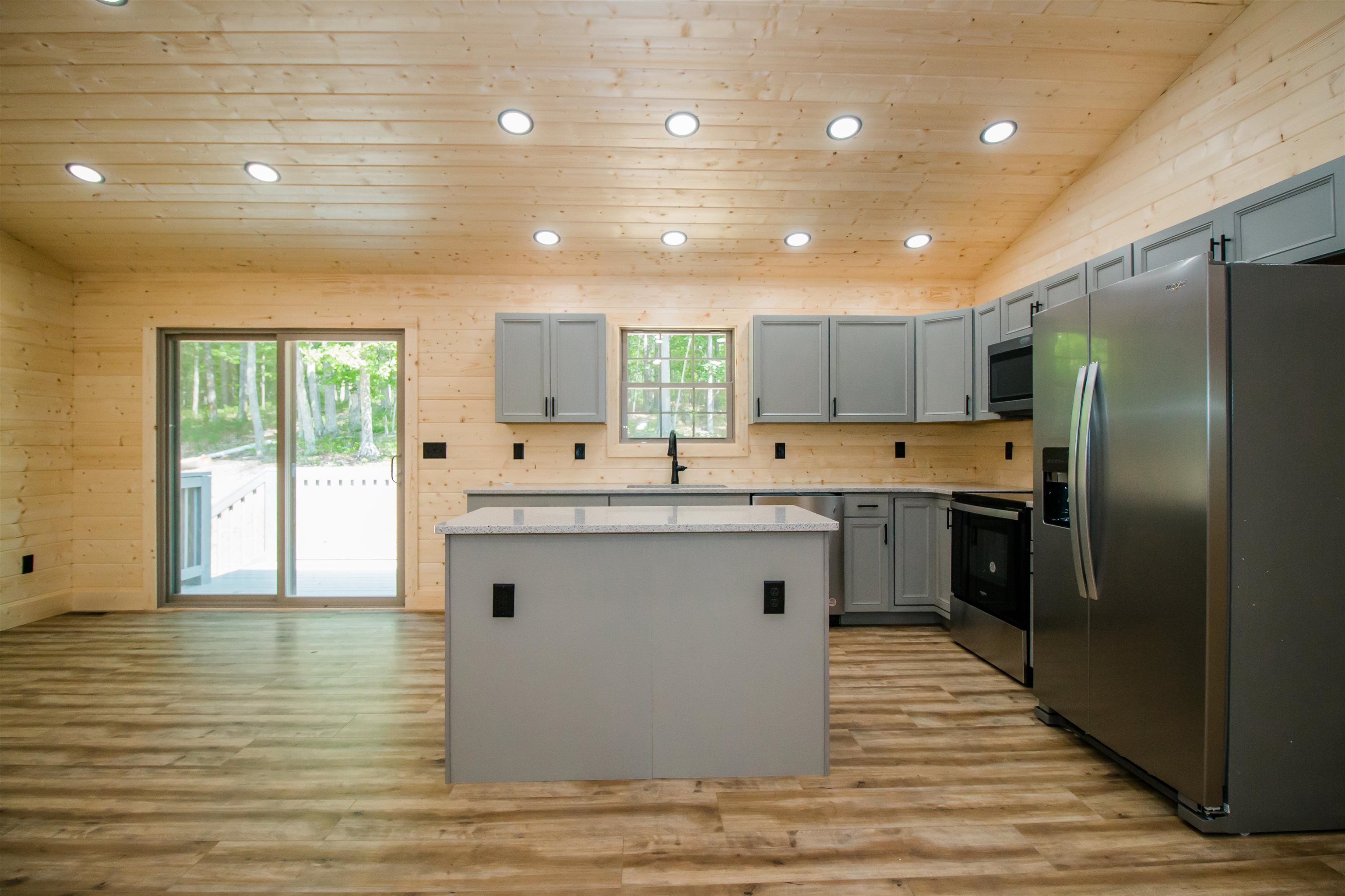 60 Trout Pass Mathias, WV 26812 - Photo 31 of 46 a kitchen with kitchen island granite countertop a sink a counter top stainless steel appliances and cabinets